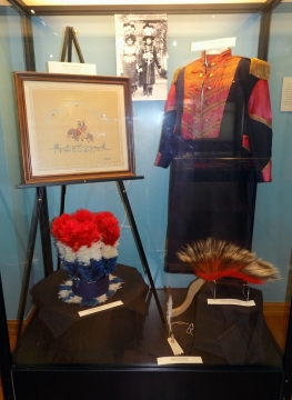 Case with Osage wedding coat and hat and roach