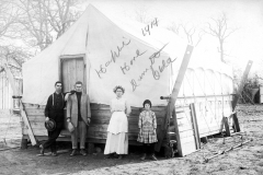 Family posing in front of their temporary oilfield house, 1914