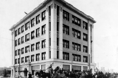 Construction workers pose in front of Pioneer Building, 4th & Boston, following its completion, 1911