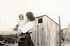 Red Cross worker holding young victim of Tulsa Race Massacre