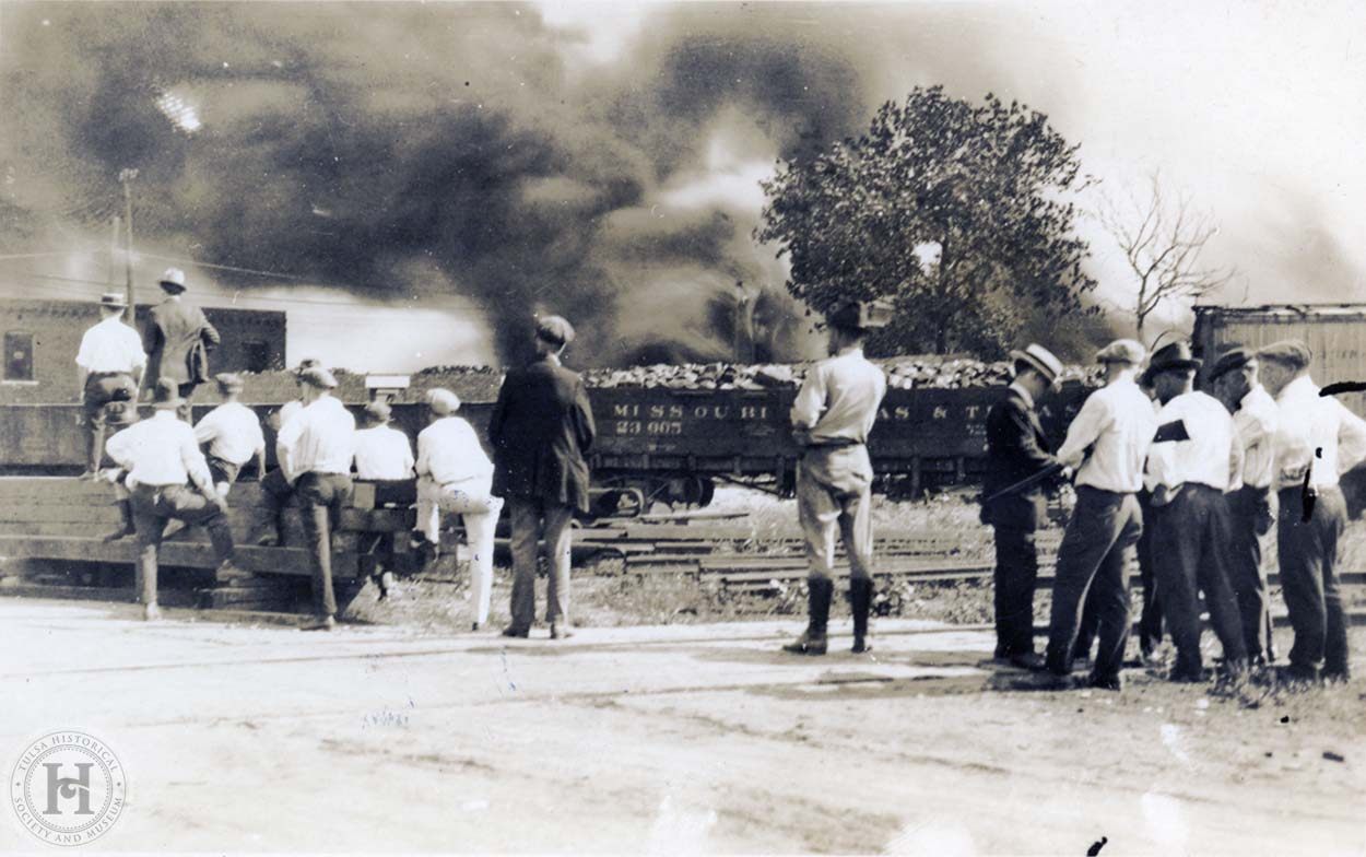 ...the railroad tracks on Greenwood Avenue watching smoke rise from a burni...