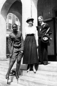 Soldier, volunteer, and sailor on the steps of Tulsas War Savings Bank during WWI